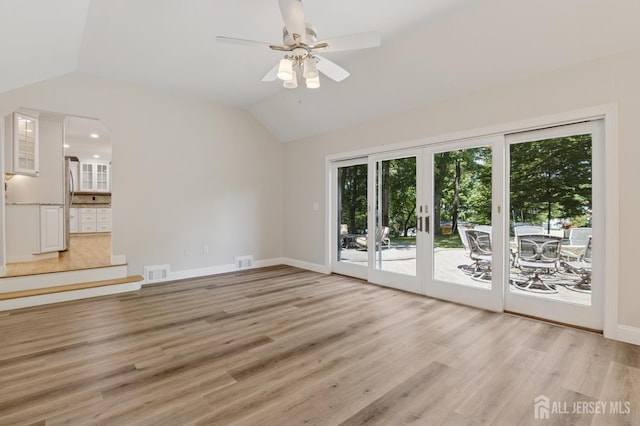 3 Cedar Ln, Milltown, NJ 08850 - unfurnished living room featuring french doors, plenty of natural light, a ceiling fan, lofted ceiling, and light wood-style flooring