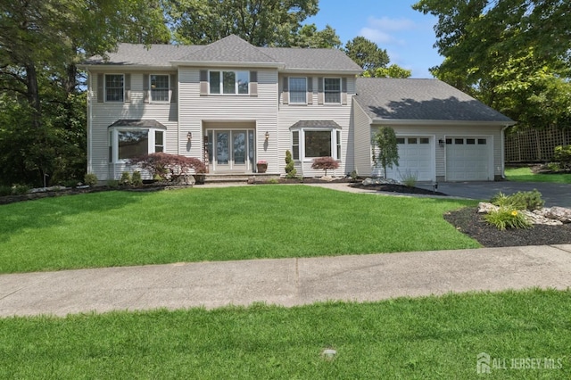 3 Cedar Ln, Milltown, NJ 08850 - colonial-style house with asphalt driveway, an attached garage, french doors, and a front yard