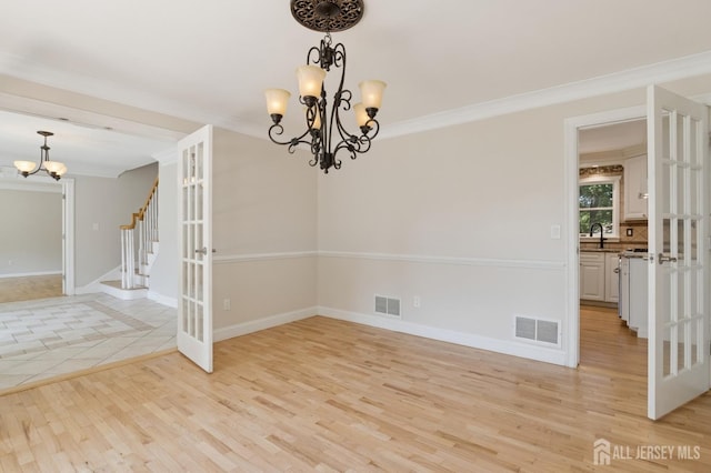 3 Cedar Ln, Milltown, NJ 08850 - empty room featuring a chandelier, light wood-style flooring, stairs, and ornamental molding