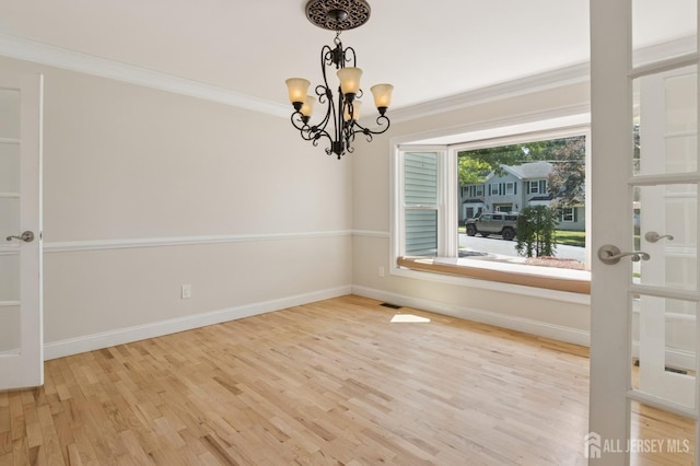 3 Cedar Ln, Milltown, NJ 08850 - spare room featuring wood finished floors, a chandelier, and ornamental molding