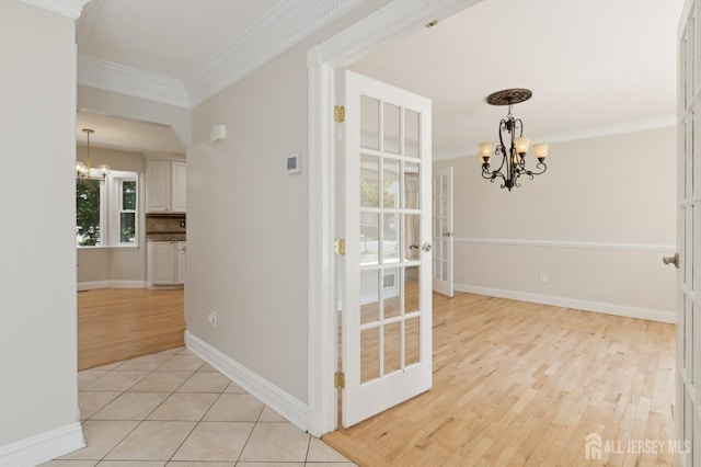 3 Cedar Ln, Milltown, NJ 08850 - hall featuring a chandelier, ornamental molding, light wood-style floors, and french doors