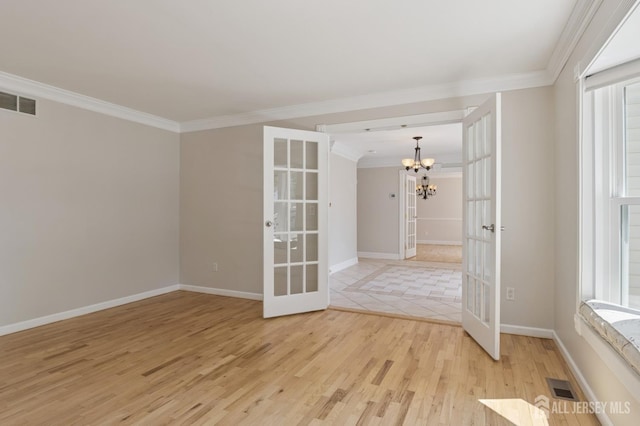 3 Cedar Ln, Milltown, NJ 08850 - unfurnished room with french doors, a chandelier, ornamental molding, and light wood-style flooring