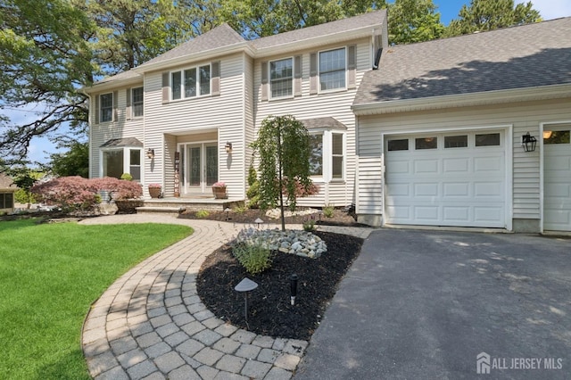 3 Cedar Ln, Milltown, NJ 08850 - colonial-style house featuring driveway, a front yard, an attached garage, and roof with shingles