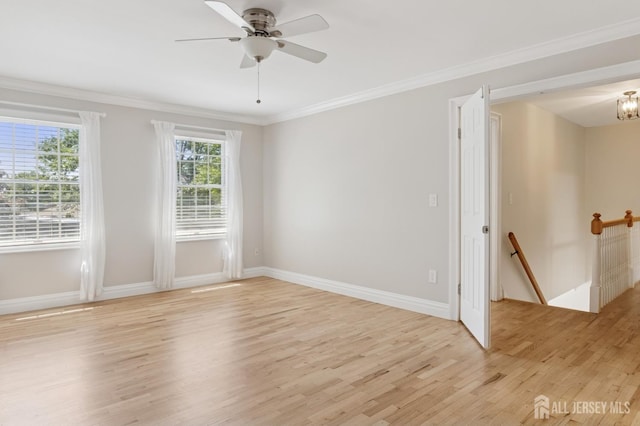 3 Cedar Ln, Milltown, NJ 08850 - empty room with light wood-style flooring, ornamental molding, a ceiling fan, and a chandelier
