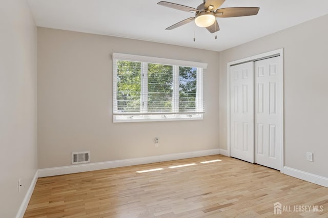 3 Cedar Ln, Milltown, NJ 08850 - unfurnished bedroom with light wood-style floors, a closet, and a ceiling fan
