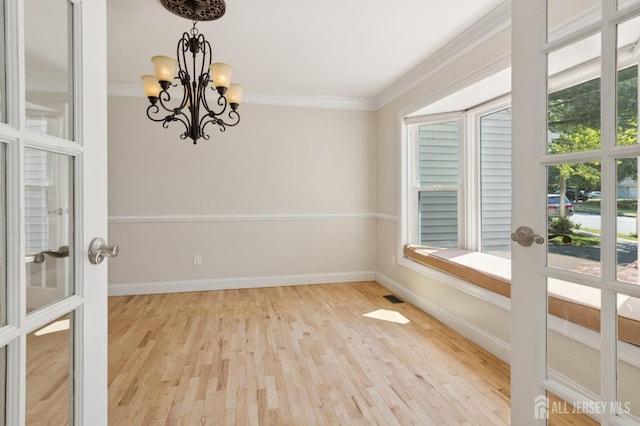 3 Cedar Ln, Milltown, NJ 08850 - spare room featuring plenty of natural light, a chandelier, wood finished floors, and crown molding