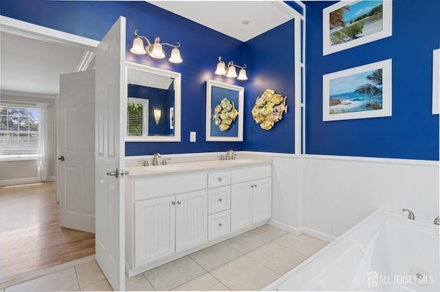 3 Cedar Ln, Milltown, NJ 08850 - bathroom with double vanity, wainscoting, tile patterned floors, and a bath