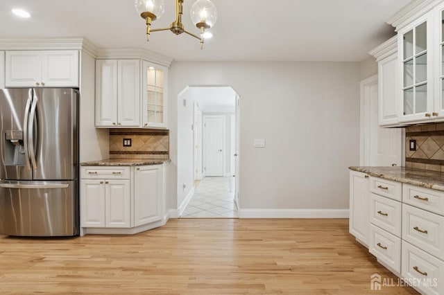 3 Cedar Ln, Milltown, NJ 08850 - kitchen with stainless steel fridge with ice dispenser, arched walkways, a chandelier, decorative backsplash, and recessed lighting