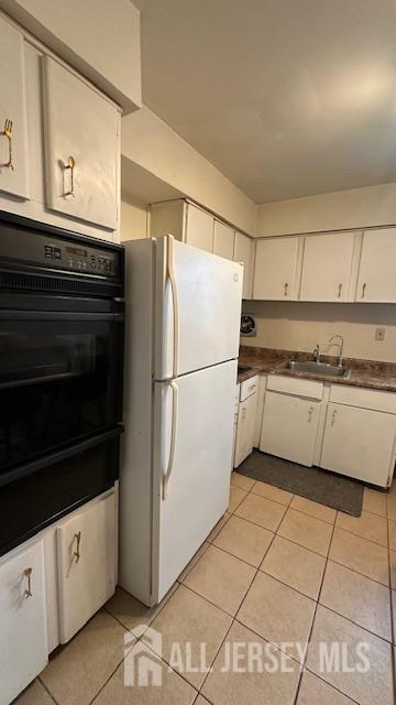 46 Gramercy Gdns, Middlesex, NJ 08846 - kitchen with freestanding refrigerator, oven, light tile patterned floors, and a sink