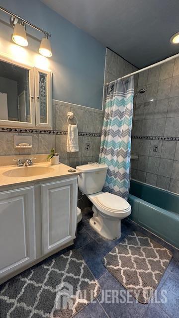 46 Gramercy Gdns, Middlesex, NJ 08846 - bathroom with toilet, shower / tub combo with curtain, vanity, tile patterned flooring, and tile walls