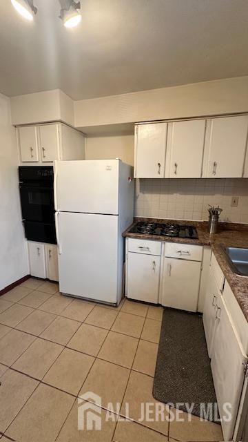 46 Gramercy Gdns, Middlesex, NJ 08846 - kitchen featuring black appliances, white cabinets, light tile patterned floors, backsplash, and a warming drawer