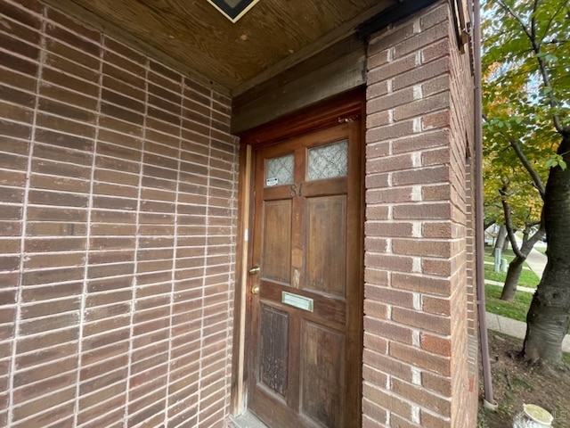 property entrance with brick siding