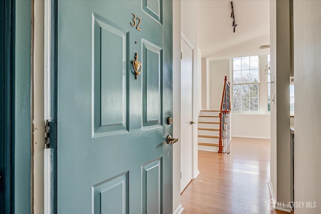 entryway with track lighting and light wood-type flooring