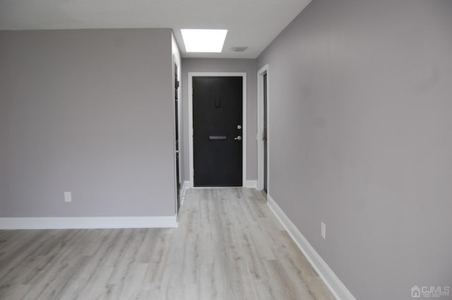 interior space featuring light wood finished floors and baseboards