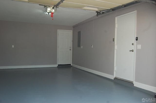 garage with a garage door opener, electric panel, and baseboards