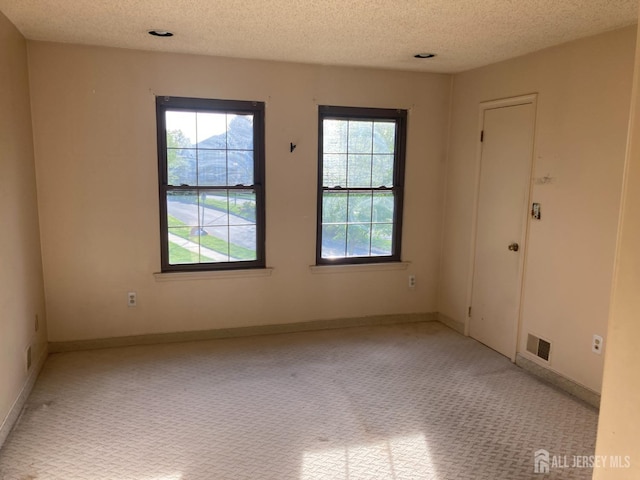 134 Hatfield Ln, East Brunswick, NJ 08816 - empty room with carpet flooring, a textured ceiling, and baseboards