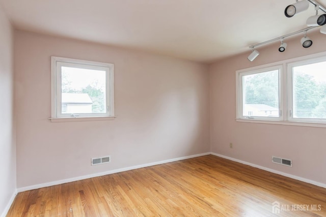 14 Agate Rd, East Brunswick, NJ 08816 - empty room with baseboards, track lighting, and light wood-type flooring