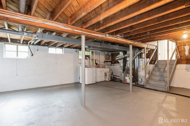 14 Agate Rd, East Brunswick, NJ 08816 - below grade area with gas water heater, separate washer and dryer, stairs, heating unit, and concrete block wall