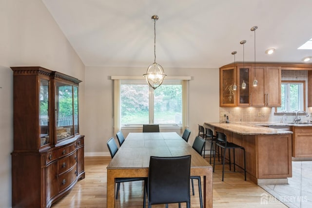 14 Agate Rd, East Brunswick, NJ 08816 - dining room featuring light wood finished floors, a chandelier, vaulted ceiling, baseboards, and recessed lighting