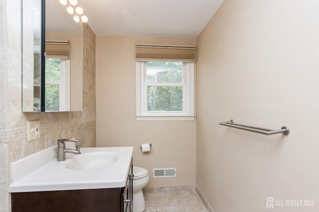14 Agate Rd, East Brunswick, NJ 08816 - bathroom featuring toilet, vanity, healthy amount of natural light, and baseboards