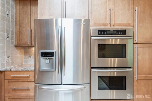 14 Agate Rd, East Brunswick, NJ 08816 - kitchen featuring stainless steel appliances, backsplash, light stone countertops, and brown cabinets