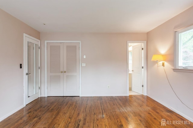 14 Agate Rd, East Brunswick, NJ 08816 - empty room with wood finished floors and baseboards