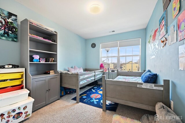 bedroom featuring light colored carpet