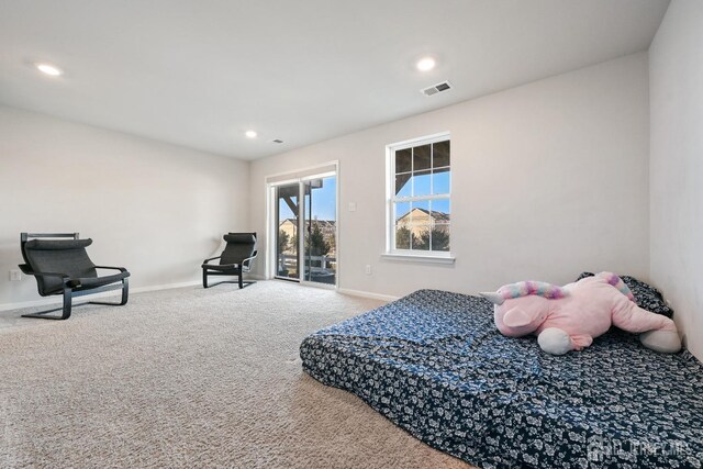 carpeted bedroom with access to exterior