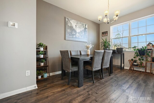 dining room featuring an inviting chandelier and dark hardwood / wood-style flooring