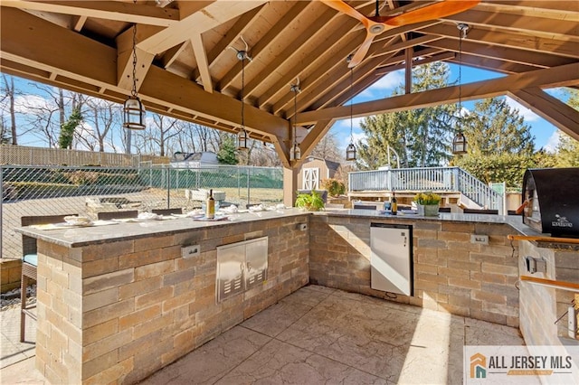 view of patio with a grill, a gazebo, and a deck