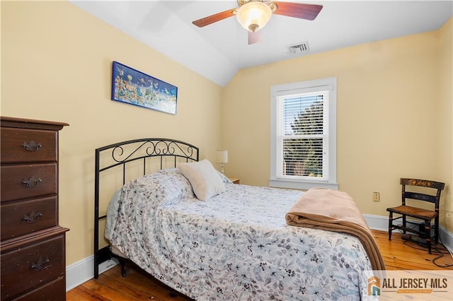 bedroom with lofted ceiling, hardwood / wood-style flooring, and ceiling fan