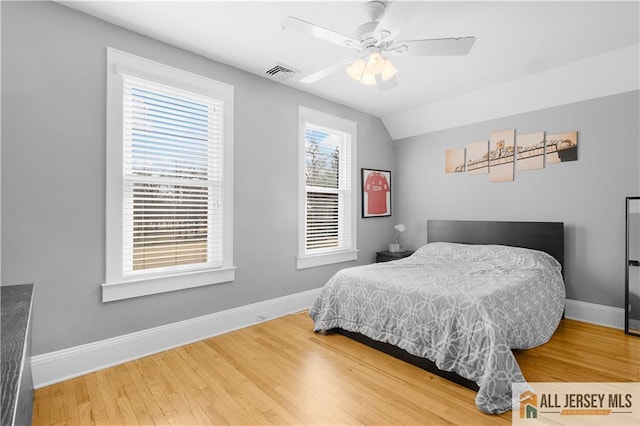 bedroom with lofted ceiling, hardwood / wood-style flooring, and ceiling fan