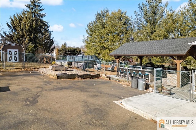 exterior space featuring a gazebo and a storage unit