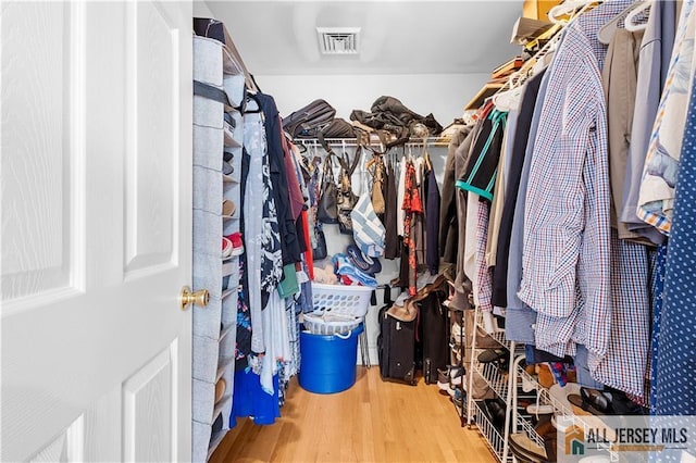 walk in closet featuring hardwood / wood-style flooring