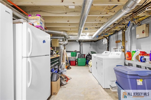 basement featuring white fridge and separate washer and dryer