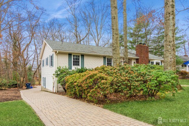 view of property exterior featuring a lawn