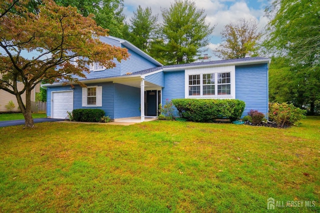 view of front of property with a garage and a front yard