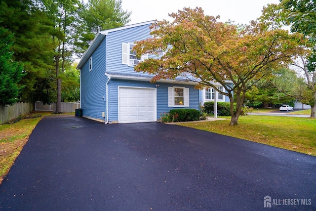 view of front of home featuring a garage and a front lawn