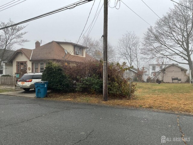 view of side of home featuring a lawn