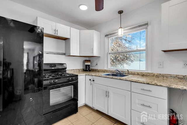 kitchen featuring pendant lighting, sink, black appliances, and white cabinets