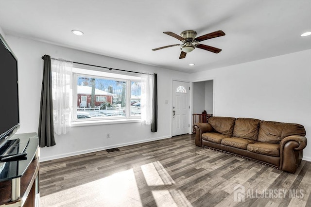 living room featuring hardwood / wood-style flooring and ceiling fan