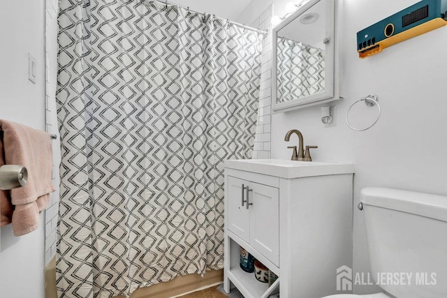 full bathroom featuring vanity, shower / bath combo with shower curtain, and toilet