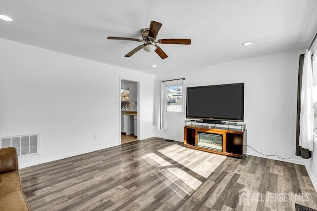 unfurnished living room with ceiling fan, visible vents, wood finished floors, and recessed lighting