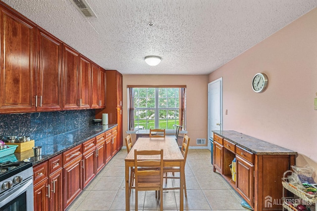 199 Prestwick Way, Edison, NJ 08820 - kitchen with stainless steel range with gas cooktop, a textured ceiling, tasteful backsplash, dark stone counters, and light tile patterned flooring