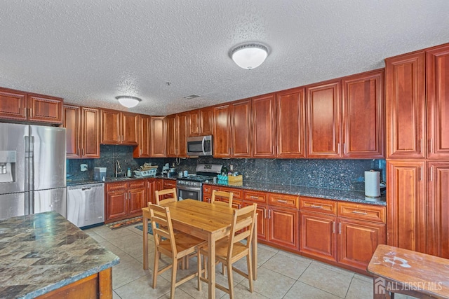 199 Prestwick Way, Edison, NJ 08820 - kitchen with appliances with stainless steel finishes, light tile patterned flooring, backsplash, a textured ceiling, and dark stone counters