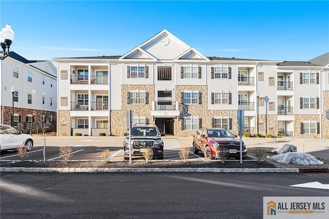 view of building exterior with uncovered parking