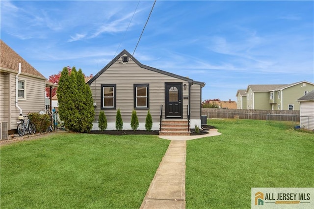 bungalow-style house featuring a front lawn