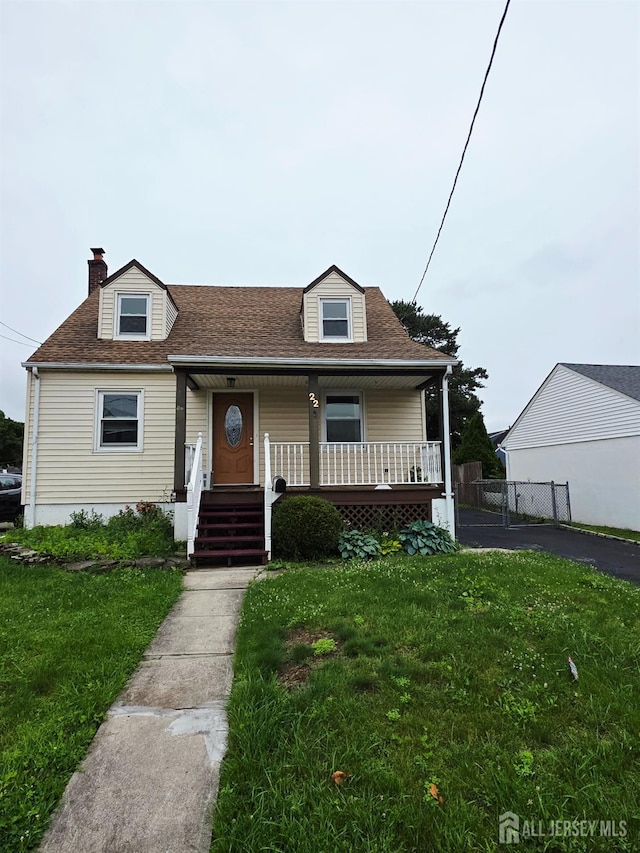22 State St, Carteret, NJ 07008 - bungalow-style home with covered porch, a front lawn, roof with shingles, and a chimney