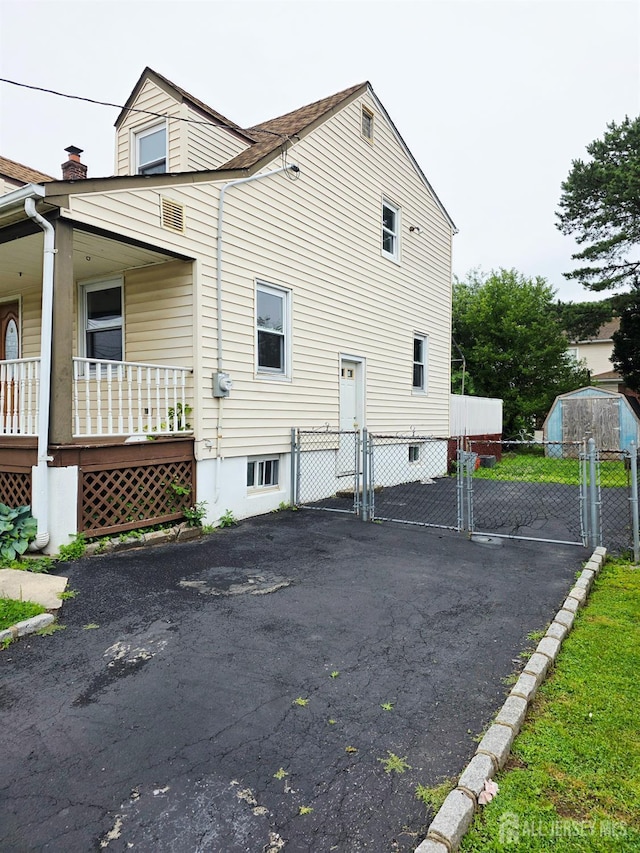 22 State St, Carteret, NJ 07008 - view of home's exterior featuring a gate and covered porch