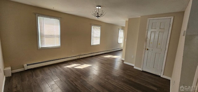 unfurnished room with a notable chandelier, dark hardwood / wood-style floors, and a baseboard radiator